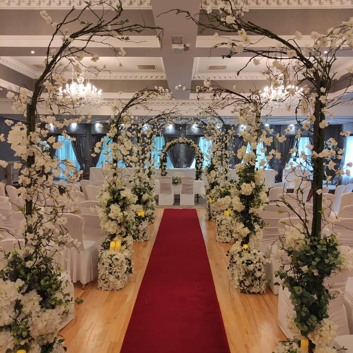 Enchanted wedding decor package with blossom arches and aisle flowers