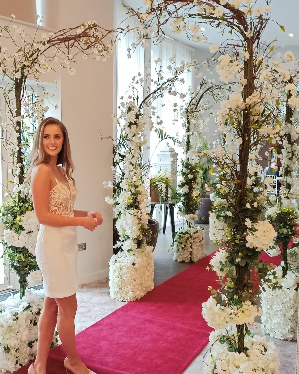 Enchanted wedding aisle styling with floral arch and ceremony decor