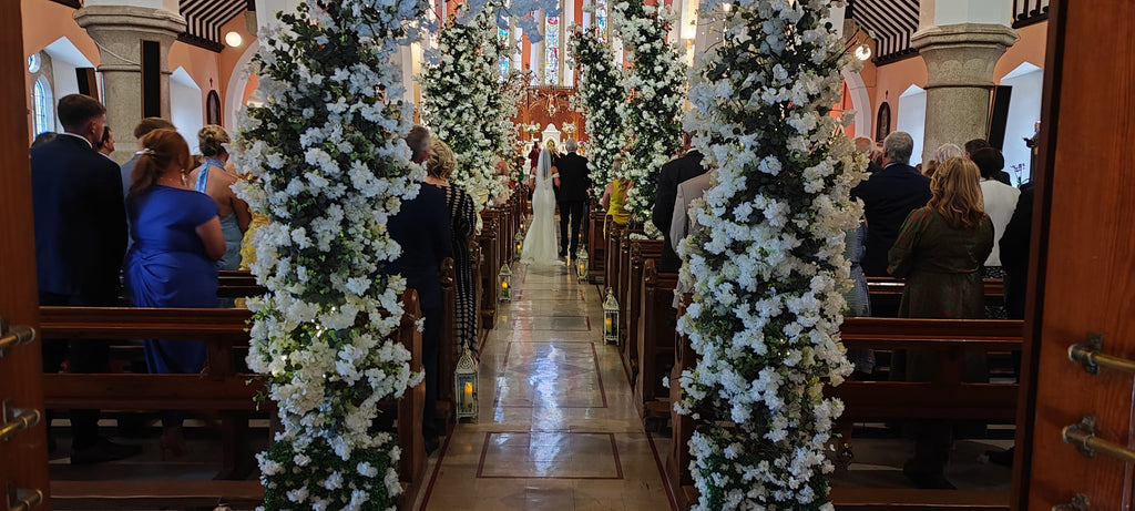 Enchanted wedding package floral entrance arch with white flowers and greenery