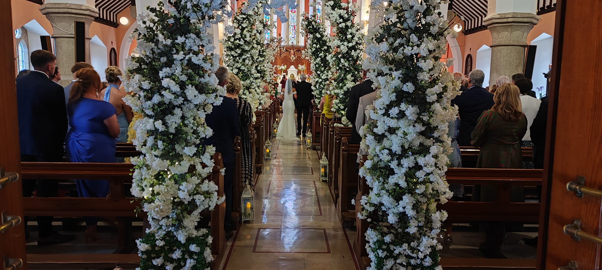Enchanted wedding package floral entrance arch with white flowers and greenery