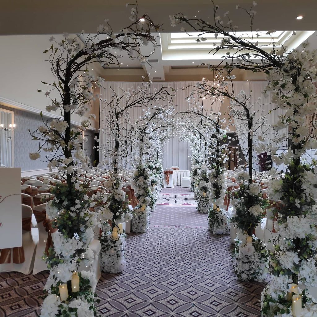 Full wedding decor package ceremony option with Enchanted blossom tree aisle arches and lanterns