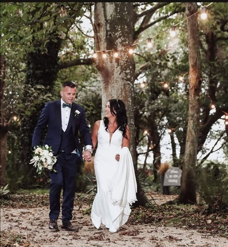 Bride and groom walking together outdoors after their wedding ceremony